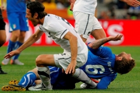 Ital Daniele De Rossi (na zemi) v souboji s Ivanem Vicelichem.