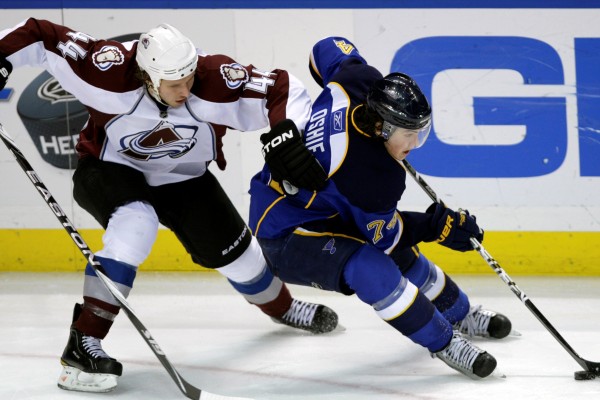 T. J. Oshie ze St. Louis (vpravo) se protahuje kolem Ryana Wilsona z Colorada. 