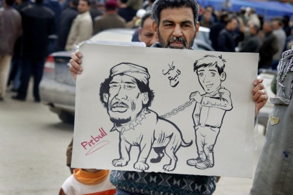 Karikatura libyjského vůdce jako psa na prodej.