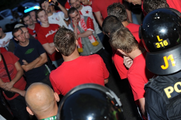Hráči Slavie (zády v červených trikách) vysvětlují fanouškům současné výsledky.
