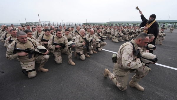 Gruzínský pravoslavný kněz žehná vojákům před jejich nasazením v Afghánistánu.