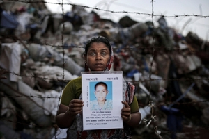 Jahanana Begumová s obrázkem své 16leté dcery Lizy Aktar, která zahynula v troskách textilky Rana Plaza v Savaru.