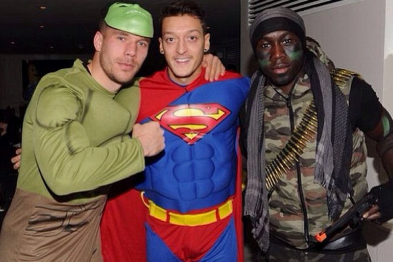 Zleva: Lukas Podolski jako Hulk, Mesut Özil v masce Supermana a voják Bacary Sagna. Zleva: Lukas Podolski jako Hulk, Mesut Özil v masce Supermana a voják Bacary Sagna.