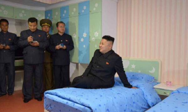 Kim III. zkouší postel v mezinárodním táboře.