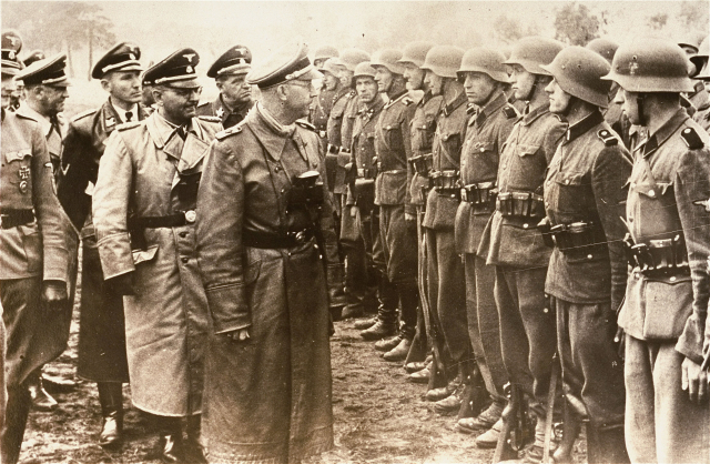 Snímek z 3. června 1944. Na obrázku hlava gestapa Heinrich Himmler promlouvá k dobrovolnické brigádě vojáků. Snímek z 3. června 1944. Na obrázku hlava gestapa Heinrich Himmler promlouvá k dobrovolnické brigádě vojáků.