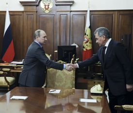 Ruský prezident Vladimir Putin (vlevo) si potřásá rukou s ruským ministrem obrany Sergejem Šojguem během setkání v Kremlu v Moskvě.