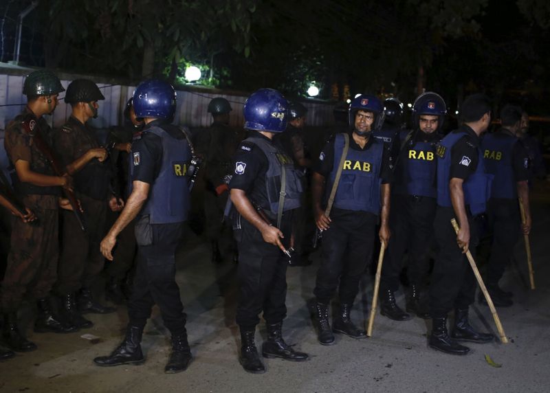 Bangladéšské bezpečností složky zasahující na místě útoku.