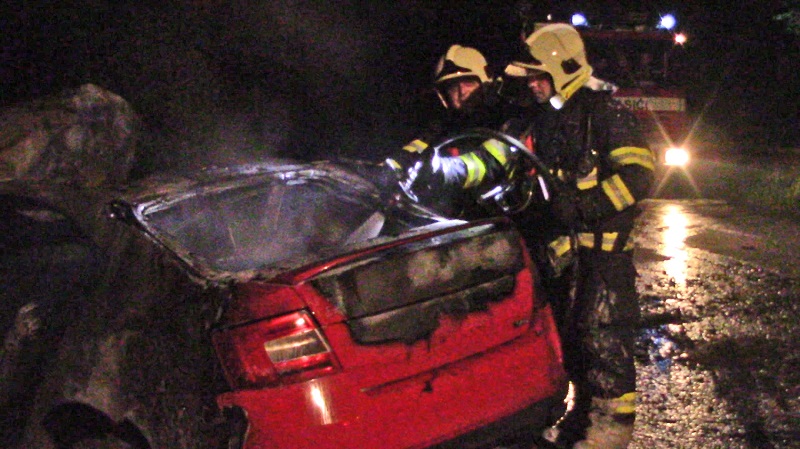 Hasiči se snaží uhasit plameny, které pohlcují auto sparťanského záložníka Aleše Čermáka.