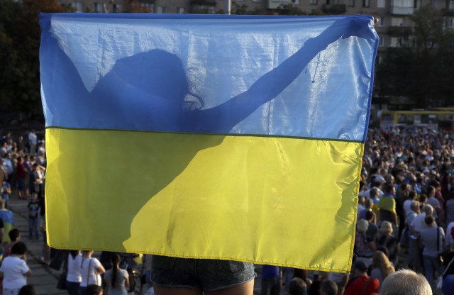 Snímek ukrajinské vlajky během protiválečných protestů ve východní části Ukrajiny.