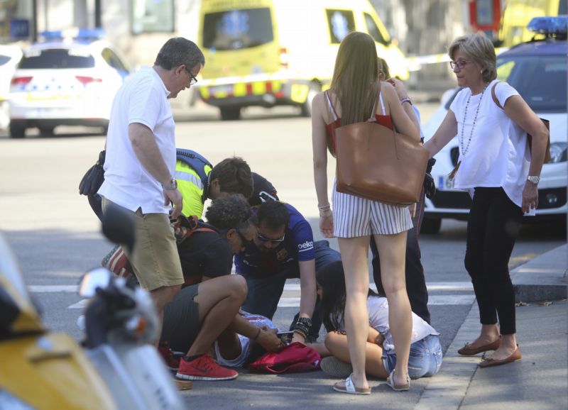 Záchranáři pomáhají zraněné osobě po útoku v Barceloně, kde najel útočník dodávkou do davu lidí.
