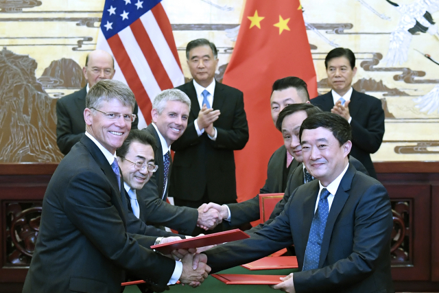 Americké a čínské společnosti podepsaly obchodní dohody. Zleva americký ministr obchodu Wilbur Ross, čínský vicepremiér Wang Yang a čínský ministr obchodu Zhong Shan během podpisu v Pekingu.
