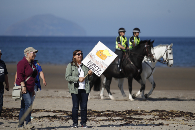 Protestující nedaleko Trumpova golfového klubu.