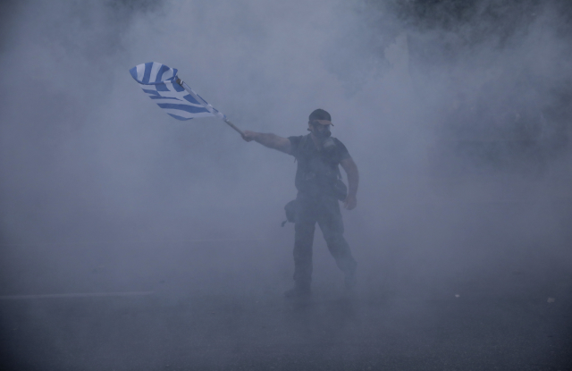 Demonstrant zahalen v hávu slzného plynu.