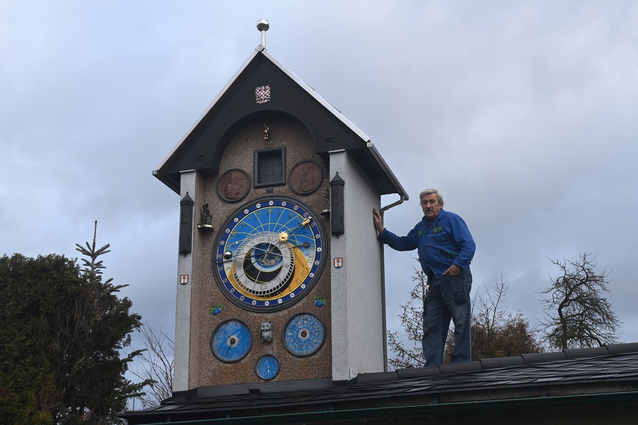 Netradiční orloj ve věžičce nad dílnou ve vilové čtvrti v Šumperku, 5. ledna 2023. Autorem je Miroslav Nečas (na snímku) a částečnou kopií s astrolábem podle vzoru staroměstského orloje v Praze sestrojoval deset let. Zarytý Moravák přidal reliéfy svatých Cyrila a Metoděje s datem příchodu na Moravu, moravskou orlicí a ratolesti švestek. Apošto nahradil figurkami představující různá řemesla. Orloj odbíjí každou celou hodinu od osmi ráno do šesti večer.