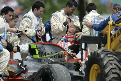 Záchranáři pečují o pilota McLarenu Heikki Kovalainenovi. Záchranáři pečují o pilota McLarenu Heikki Kovalainenovi.